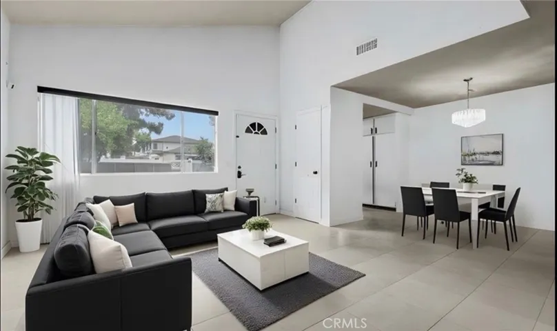 Living room, entry and dining room view - Photo has been virtually edited and staged