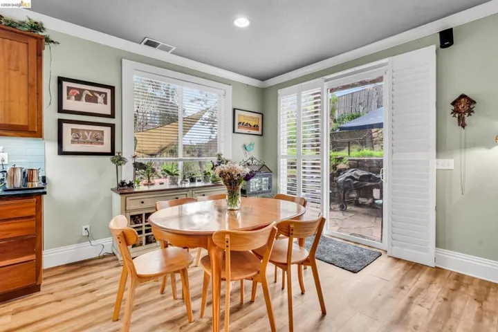 Dining area featuring crown molding, light wood-style floors, and recessed lighting