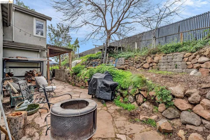 View of patio featuring a fire pit and a grill