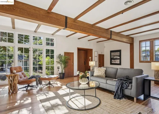 Living area with wood finished floors and beamed ceiling