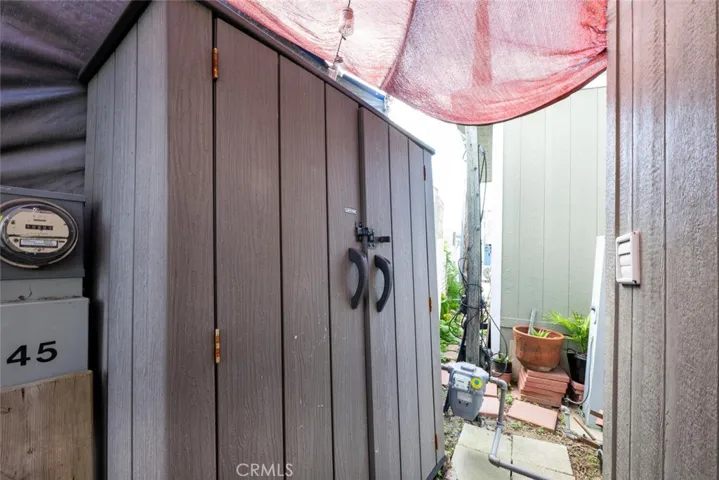 Private back patio includes storage shed