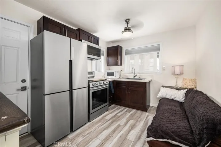 Kitchen/Living space feature: high ceilings, vinyl floors, dual paned windows with shades, ceiling fan