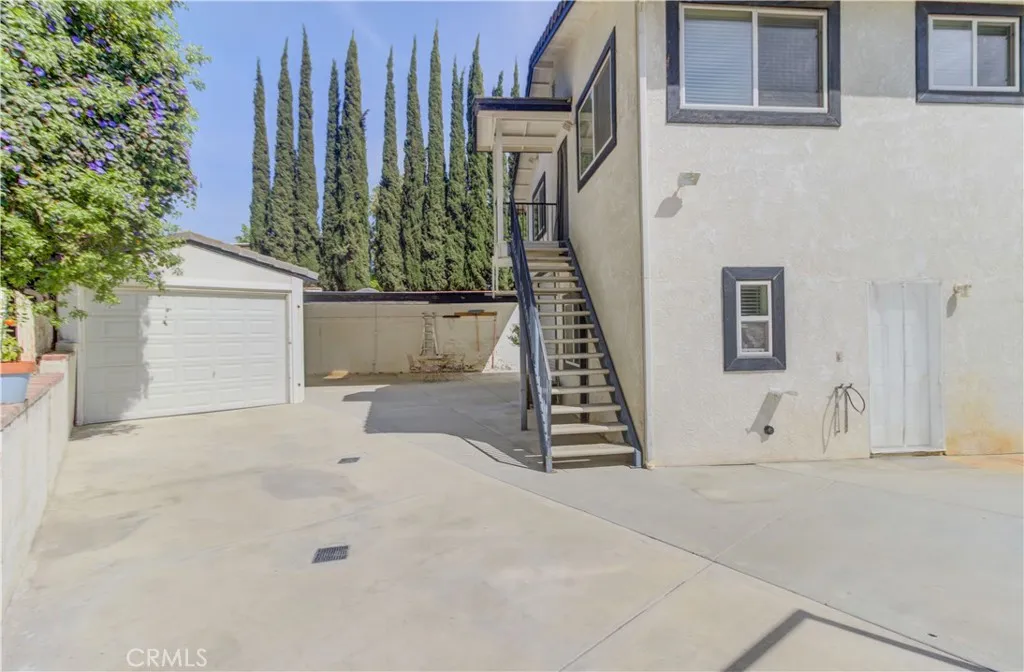 Stairs to upper apartment and door to studio.  Boat barn on left.