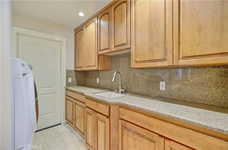 Laundry room leading to 3 car garage