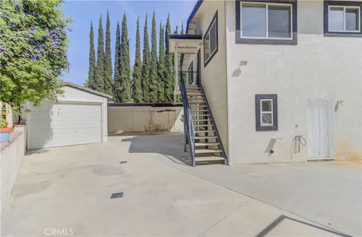 Stairs to upper apartment and door to studio.  Boat barn on left.