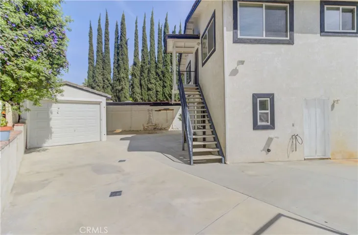 Stairs to upper apartment and door to studio.  Boat barn on left.