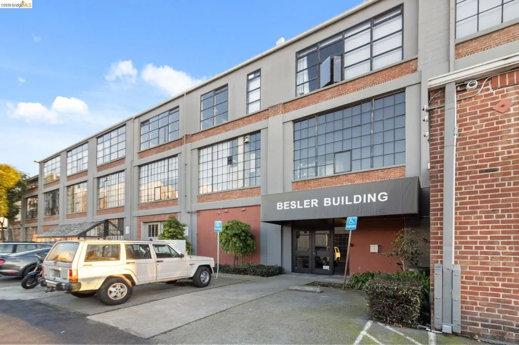 View of property featuring uncovered parking