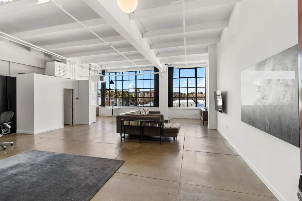 Living area with finished concrete floors and healthy amount of natural light