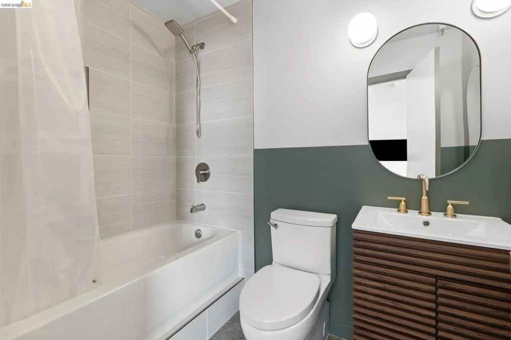 Full bath with vanity and shower / bath combination with curtain