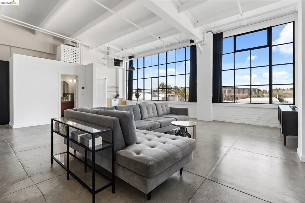 Living room with concrete flooring and a heating unit