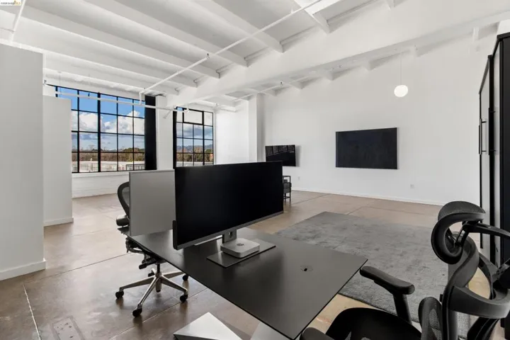 Office space featuring baseboards and beamed ceiling