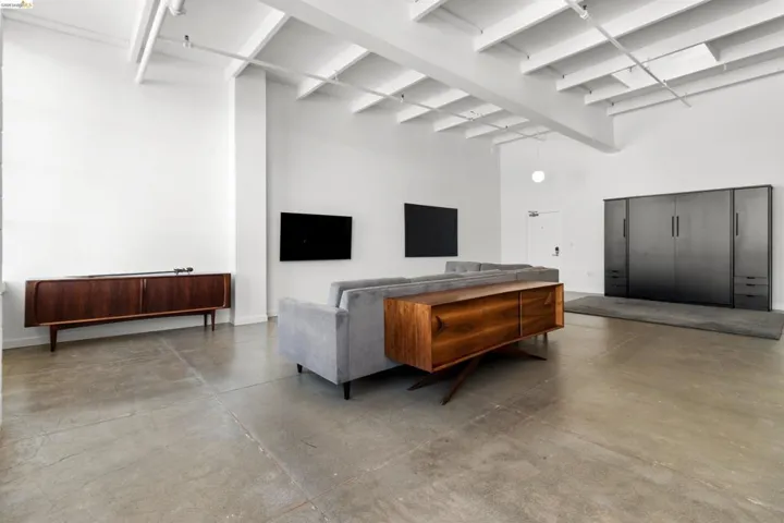 Living area featuring finished concrete flooring and baseboards