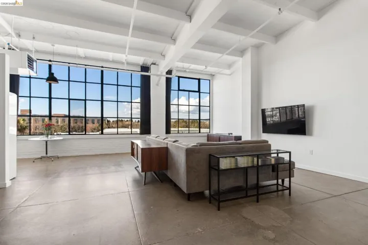 Living area featuring finished concrete floors and a heating unit