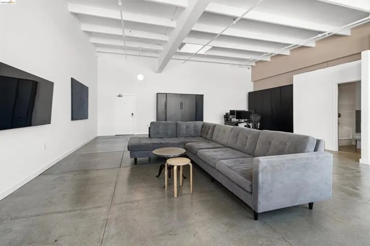 Living room featuring concrete floors and baseboards
