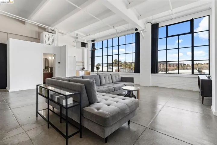 Living room with concrete flooring and a heating unit