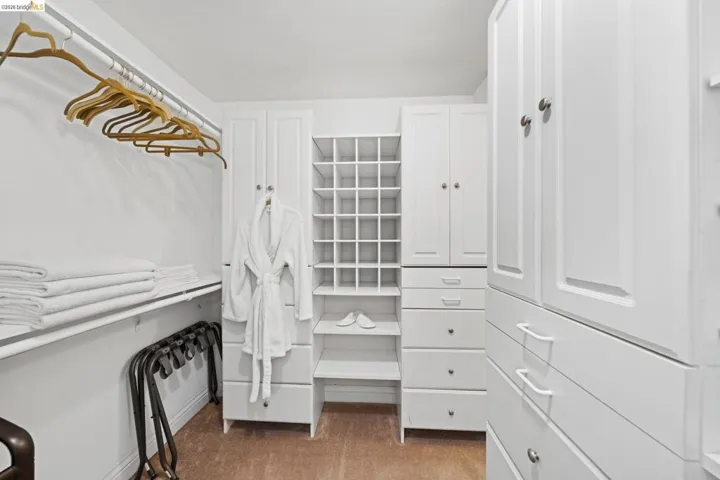 Spacious closet featuring light colored carpet