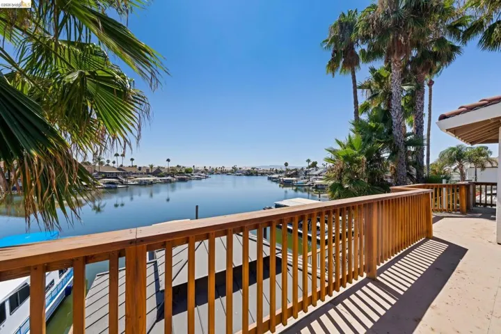 Wooden deck with a water view and a boat dock