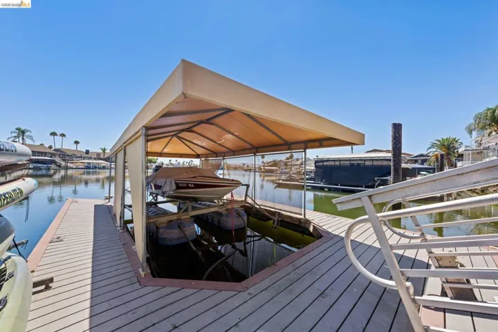 Dock with boat lift and a water view