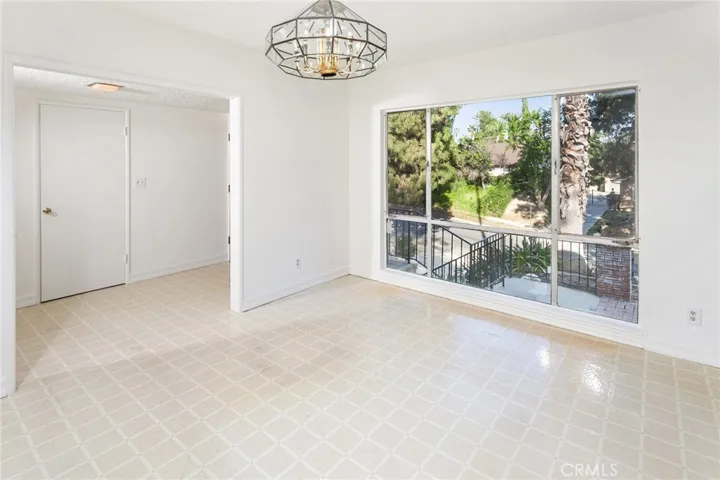 A generously sized breakfast nook with large picture window provides comfortable everyday dining.