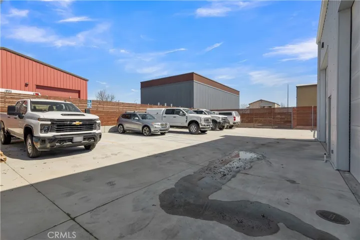 Back of building with gated & fenced parking