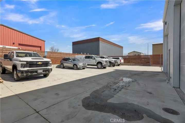 Back of building with gated & fenced parking