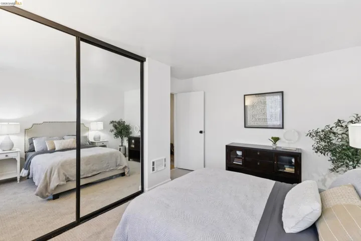 Carpeted bedroom with a closet