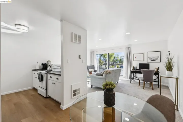 Dining room with recessed lighting, light wood finished floors, heating unit, and an office area