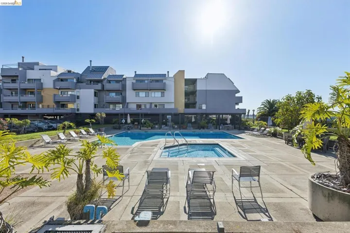 Community pool with a community hot tub, sauna, changing room and a patio area