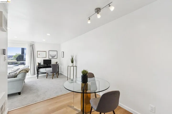 Dining room with light wood-type flooring, a desk, and recessed lighting