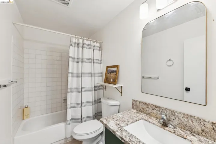 Bathroom with vanity and shower / bathtub combination with curtain
