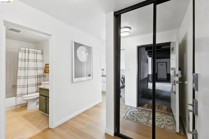 Corridor with light wood-style floors and baseboards