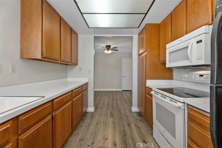 Kitchen – Well-organized kitchen with extended countertop space, upper and lower cabinetry, and natural light from corner windows. Clean lines and an efficient footprint make the space easy to use.
