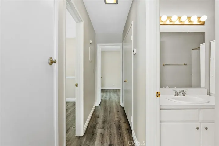Hallway – Central hallway provides a clean connection between the main living areas, bedrooms, and bath. Consistent flooring and neutral tones create a cohesive look throughout.
