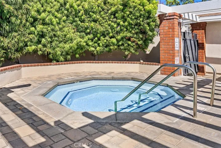 Community Spa – Inviting spa area with convenient step-in access and surrounding privacy landscaping. Thoughtfully maintained amenities enhance the overall community experience.
