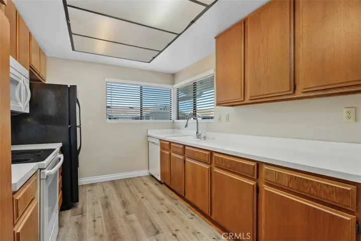 Kitchen – Light-filled kitchen featuring plenty of counter space, ample storage, and large windows that bring in natural light. The efficient design supports easy meal prep and everyday use.