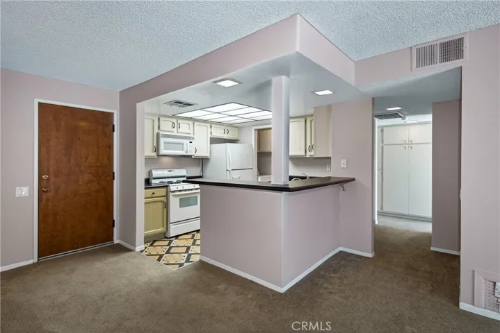 View from dining area and living room looking into kitchen