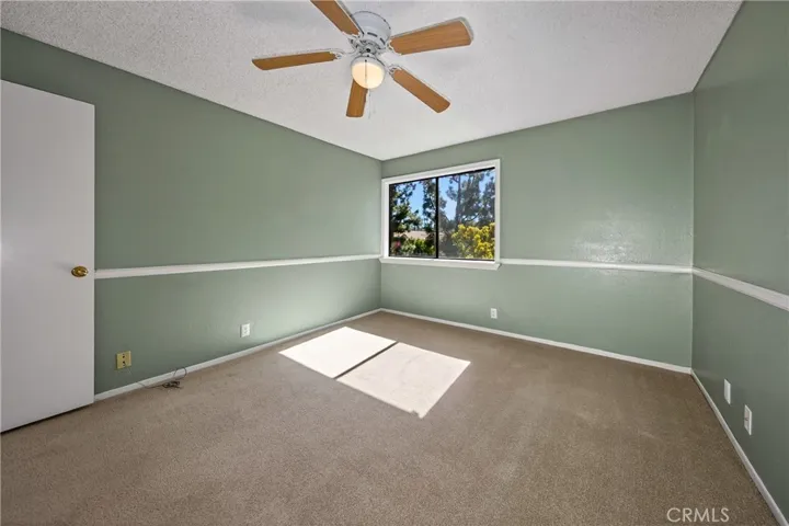 Bedroom 2.  Nice size with ceiling fan and natural light