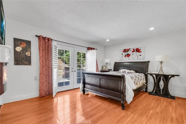 Primary Bedroom with wood floors