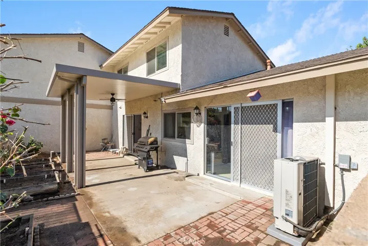 private backyard with newer patio cover, new HVAC, and garden beds