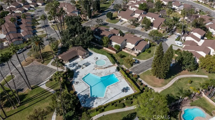 Aerial view of community pool and cabana, greenbelt space - home is to the right of the pool just above the cul de sac end