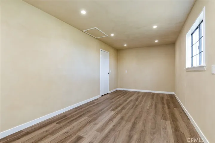 Vinyl plank flooring and recessed lighting help give the room flexibility.