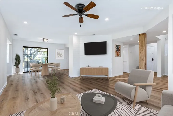 The living room flows effortlessly into the dining area, great for entertaining and everyday living. Photo has been virtually staged.