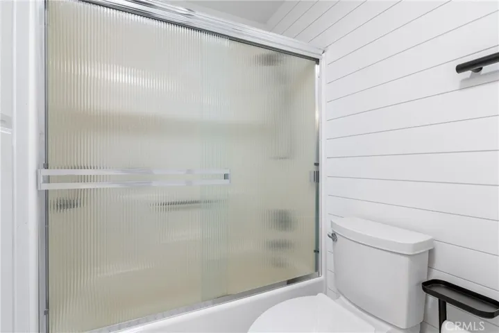 Tub/shower combination with privacy glass doors.