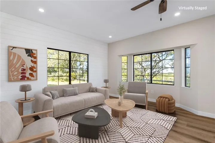 Striking shiplap walls grace the living room and give it character. Photo has been virtually staged.