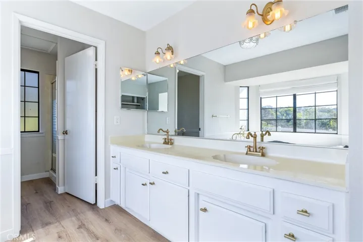 The primary bathroom features a dual sink vanity.