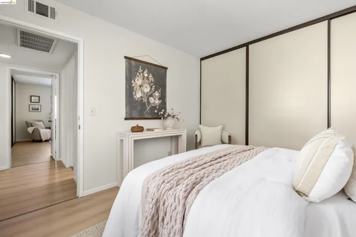 Bedroom with wood finished floors and baseboards