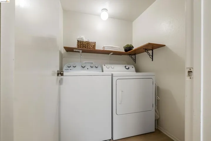 Laundry area featuring washer and dryer and baseboards