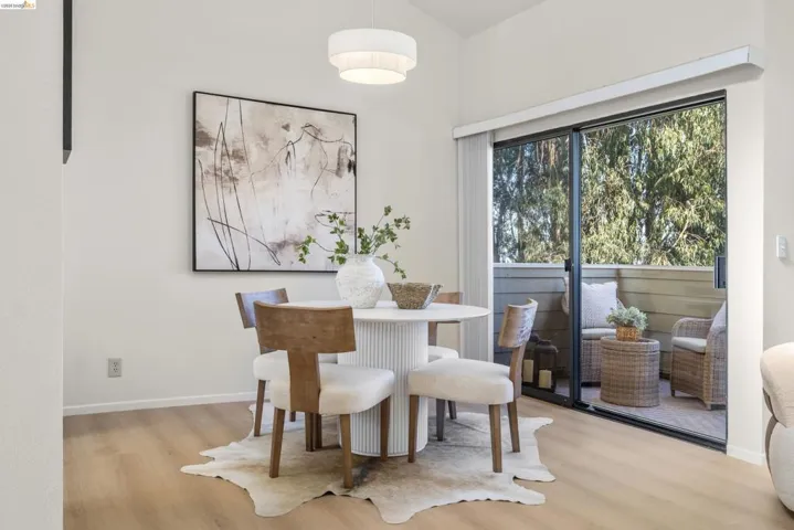 Dining area with light wood-style flooring and baseboards