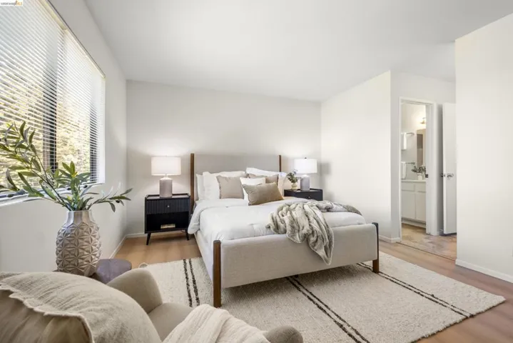 Bedroom with light wood-type flooring and baseboards