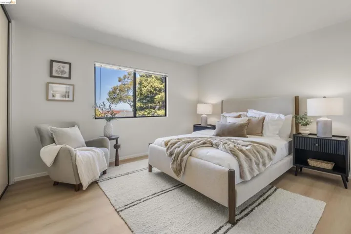 Bedroom with light wood-type flooring and a closet